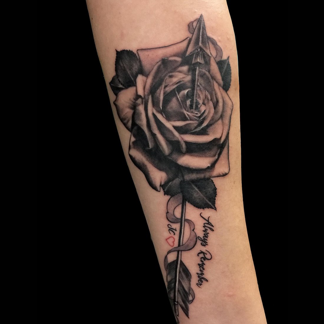 Black and grey rose on the forearm
